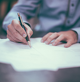 Man writing at a desk