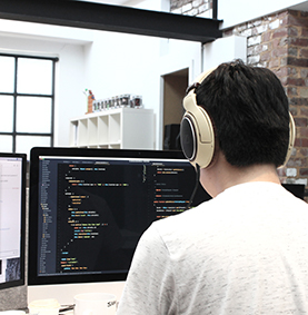 Man with headphones programming in an office